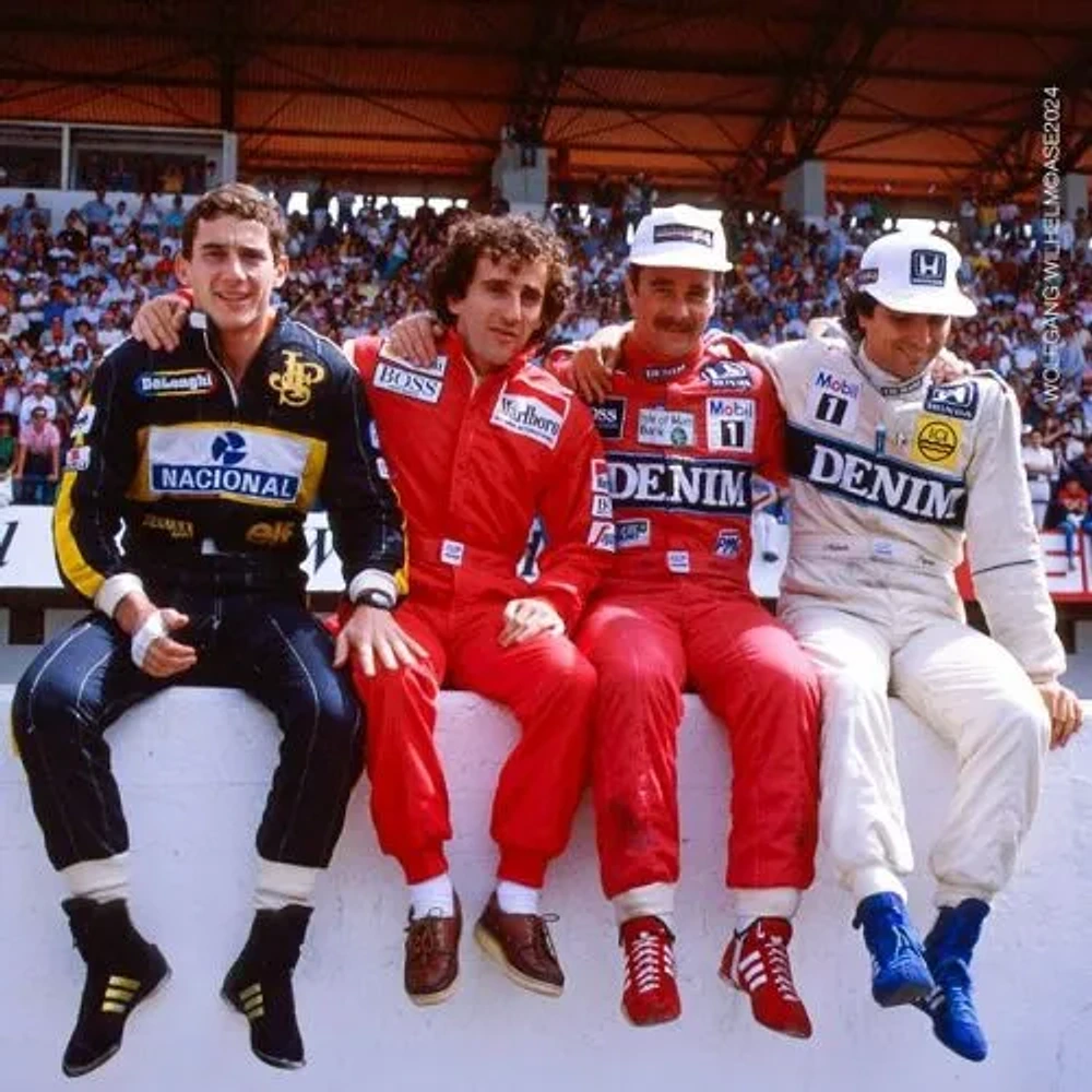 Ayrton Senna, Alain Prost, Nigel Mansell, and Nelson Piquet sitting together at the track